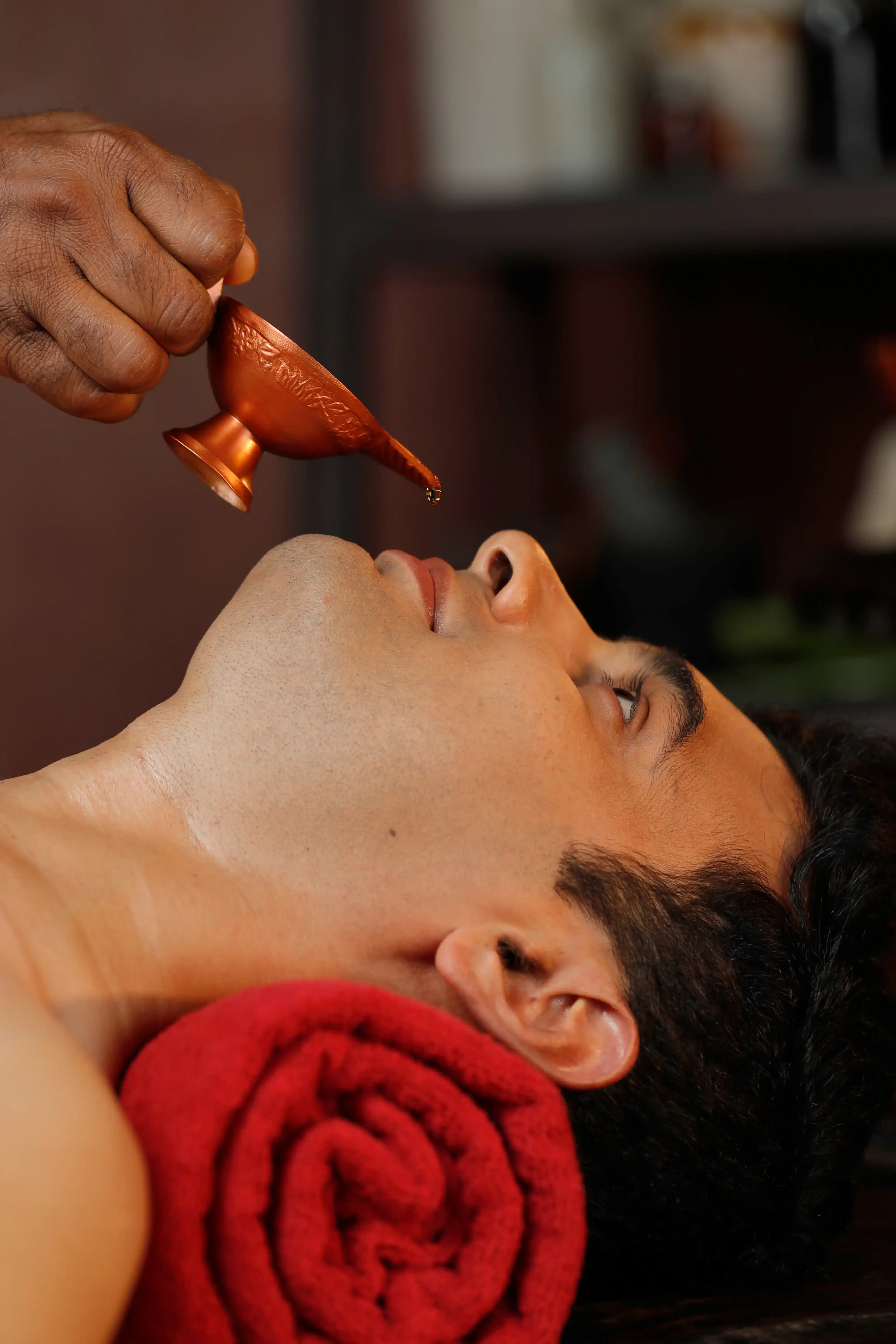 Person receiving Nasya therapy with Ayurvedic oil for sinus relief - Ayurvedic-treatment-benefits.